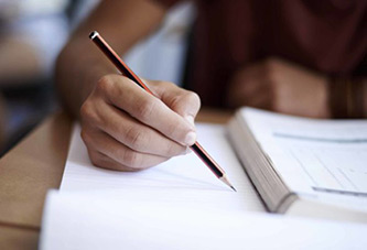 student writing in book