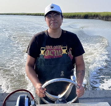 Denia Lopez steering boat