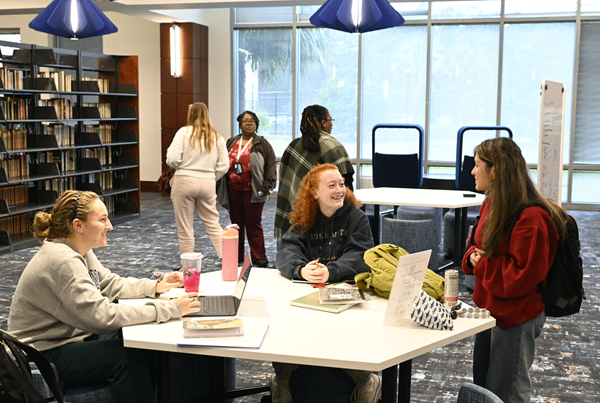 Students gathering at table 
