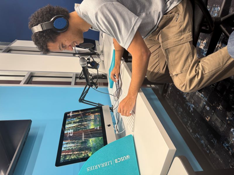 Student using podcasting equipment