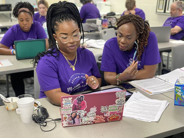 Teachers collaborating on laptop