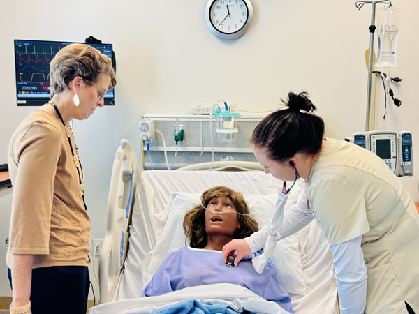 Student and faculty with manikin Student and faculty with manikin