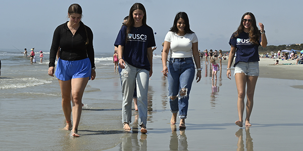 students walking on a beach