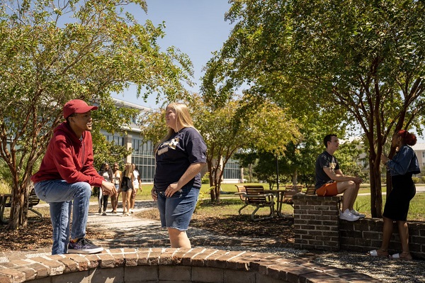 Many Students Hanging Out in Common Area Outdoors