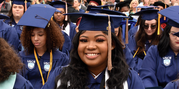 A smiling female graduate