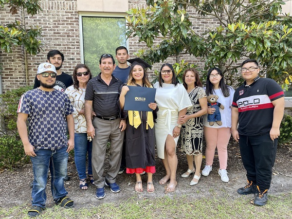 Grad Holding Diploma with Family 