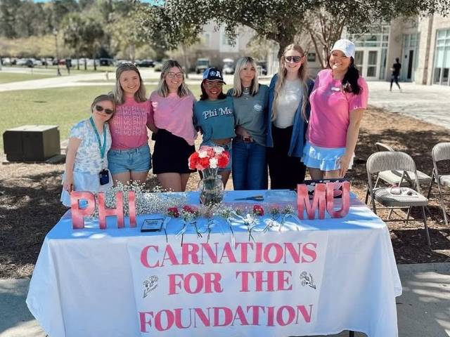 Fraternity and sorority members smiling