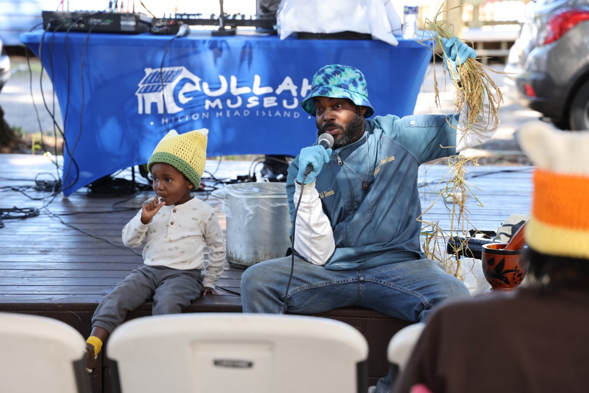 BJ Dennis and his son showing rice at the 2024 Gullah Food Festival 