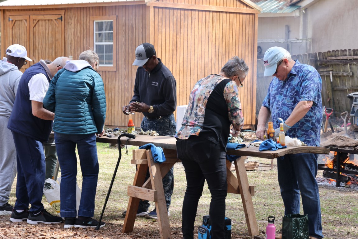 People shucking oysters at the Gullah Oyster Festival