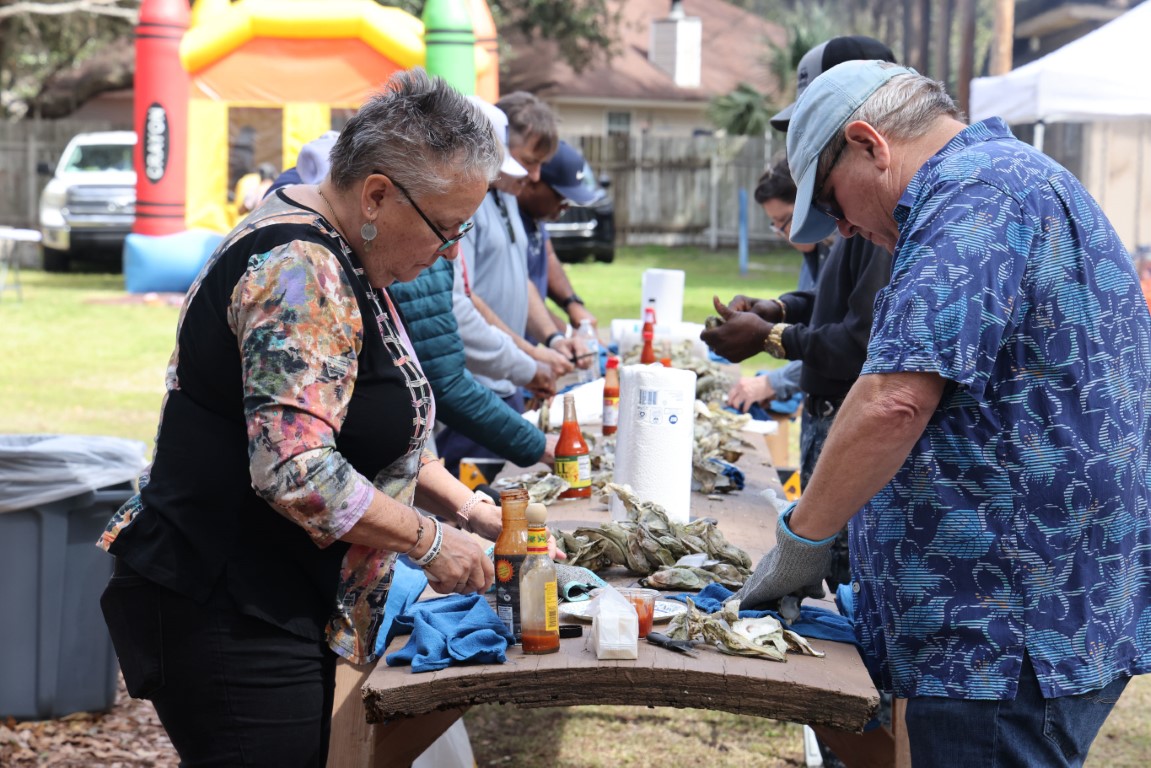 People shucking oysters at the Gullah Oyster Festival