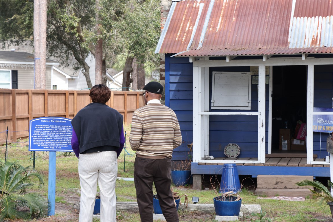 Two people looking at the Little Blue House