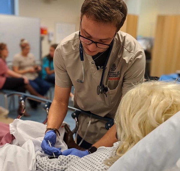 Nursing Student Injecting Mannequin