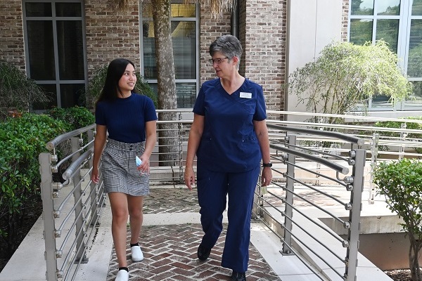 Student Walking with Faculty