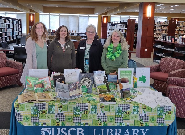 Library Staff Posed in front of Decorative Table