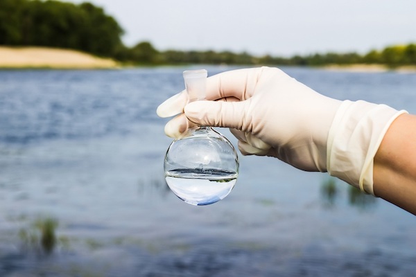 Hand holding water droplet