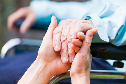 Hand holding between eldery and young hands