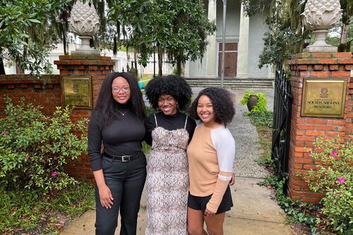African American Students smiling together outside