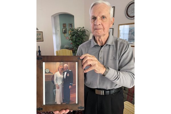 Wallace at his home with his photo