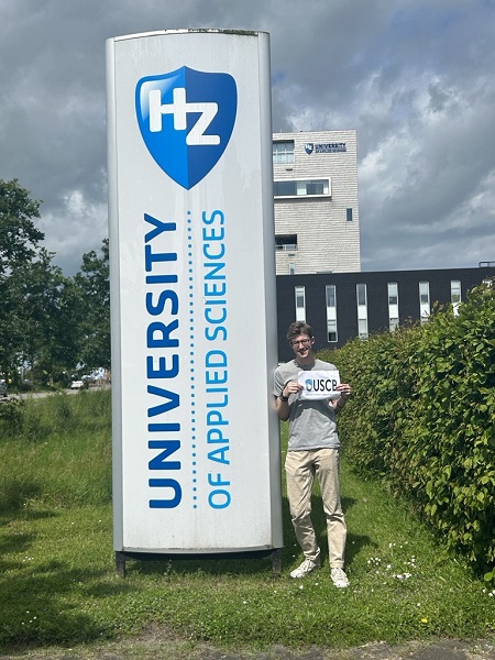 Student holding USCB sign next to HZ University Student holding USCB sign next to HZ University