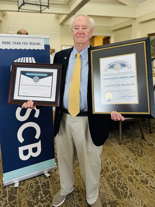 Dr. Larry Rowland Holds His Awards Dr. Larry Rowland Holds His Awards