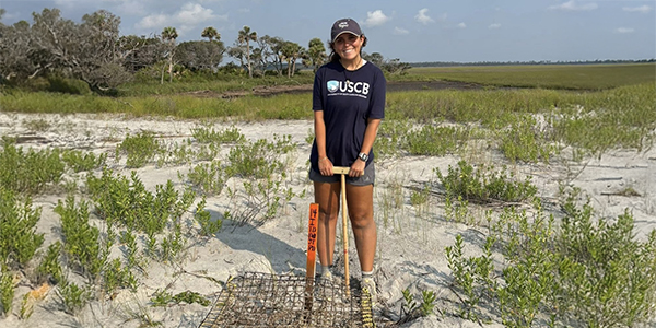 Young woman posing near a turtle nest