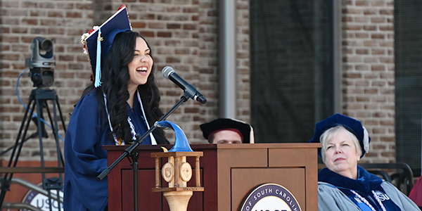 A woman speaking at a podium
