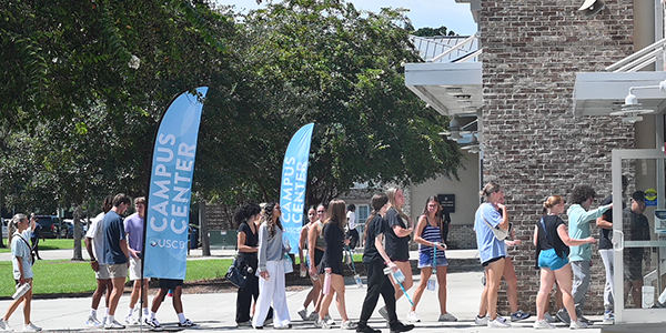 Students walking into USCB Campus Center Students walking into a building