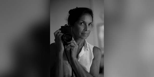 A women holding a camera reflected in a mirror 