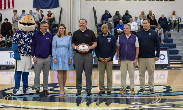 A line of people gathered on center court