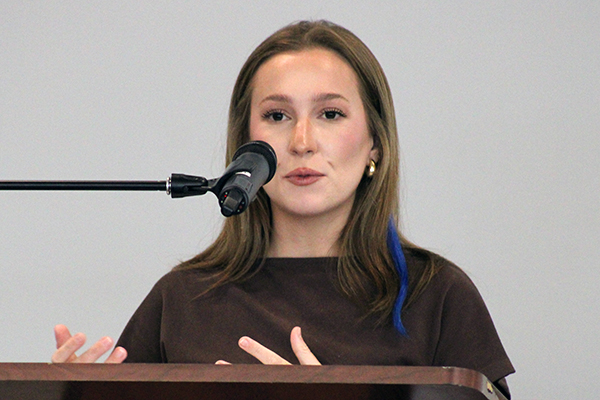 Young woman speaking at a podium