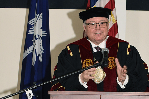 Man speaking at a podium 