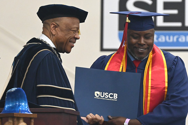 A man receiving his diploma