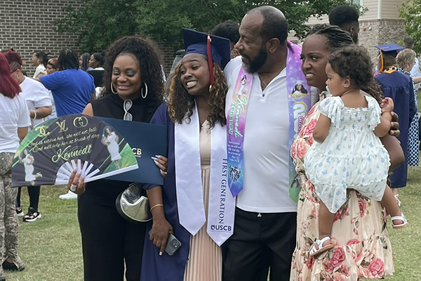 A graduate celebrating with her family