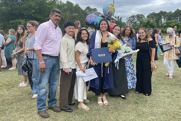 A family celebrating with a graduate
