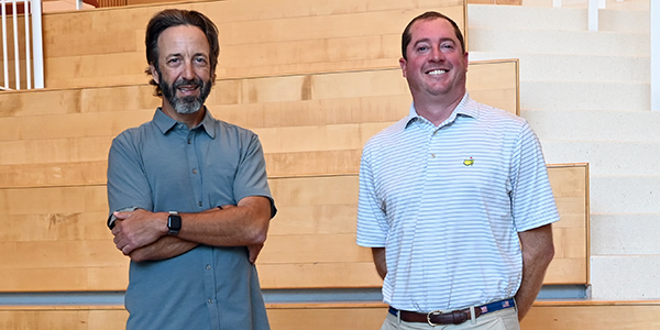 Two men standing side by side