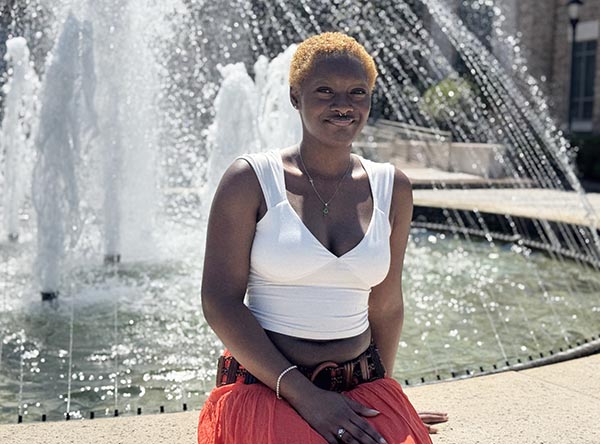 Traliya Mitchell sitting by Waterfountain